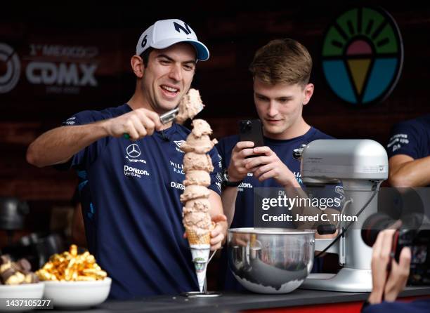 Nicholas Latifi of Canada and Williams and Logan Sargeant of United States and Williams take part in an ice cream challenge in the Paddock during...