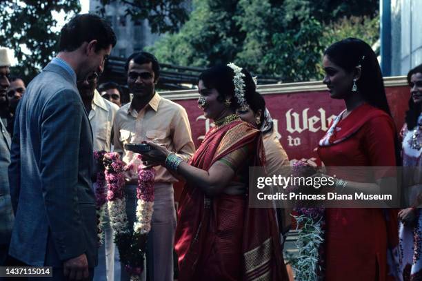 Prince Charles, Prince of Wales is welcomed to the Rajkamal Kalamandir film studio for a visit, as Indian actress Padmini Kolhapure watches, Bombay,...