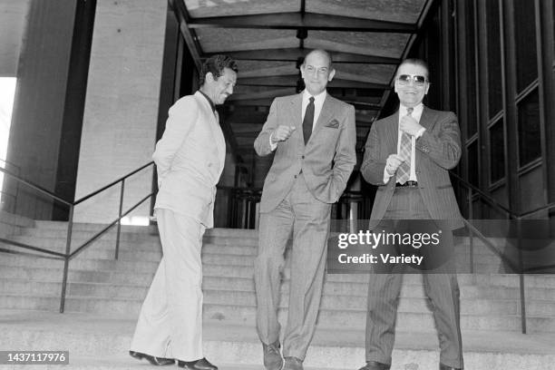 Designers Issey Miyake, Oscar de la Renta, and Karl Lagerfeld pose for a portrait outside the Four Seasons Hotel in New York City on April 12, 1984.