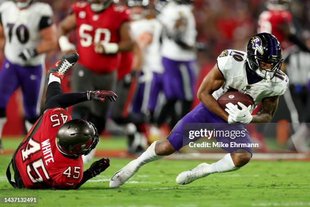 Demarcus Robinson of the Baltimore Ravens carries the ball past Devin White of the Tampa Bay Buccaneers during the second quarter at Raymond James...