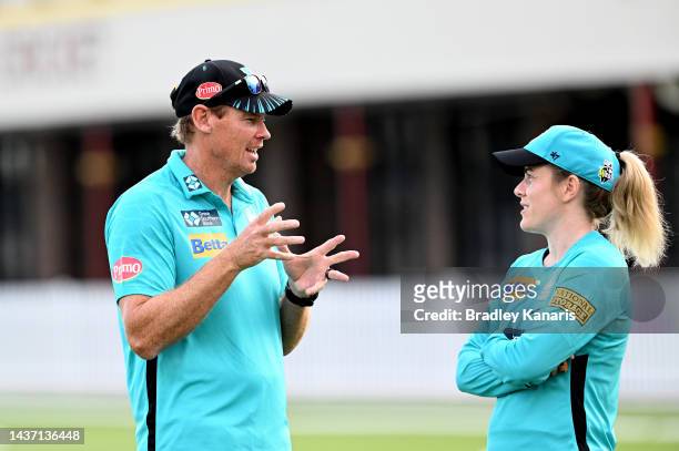 Coach Ashley Noffke of the Heat chats with Georgia Redmayne of the Heat during the warm up before the Women's Big Bash League match between the...