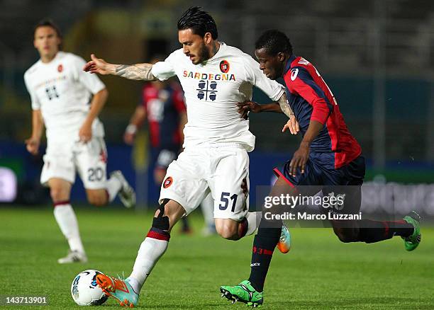 Mauricio Pinilla of Cagliari Calcio competes for the ball with Masahudu Alhassan of Genoa CFC during the Serie A match between Genoa CFC and Cagliari...