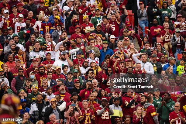 Washington Commanders and Green Bay Packers fans react to a play during the second half of the game at FedExField on October 23, 2022 in Landover,...