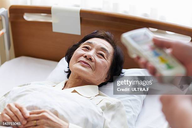 senior patient in hospital bed - nakano ward stock-fotos und bilder