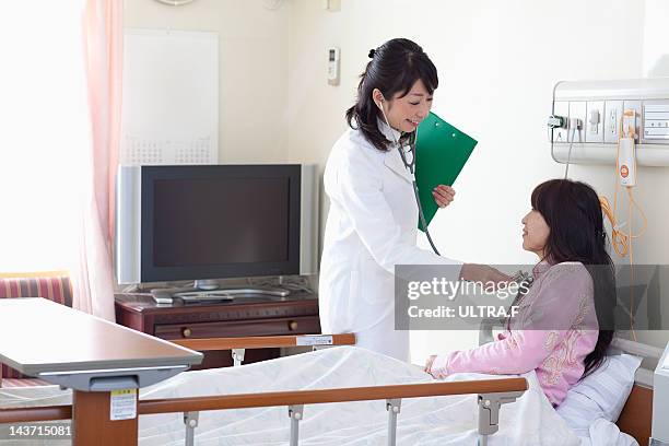 female doctor talking to a patient - nakano ward stock-fotos und bilder