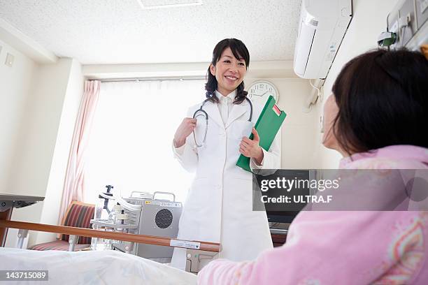 female doctor talking to a patient - nakano ward stock-fotos und bilder