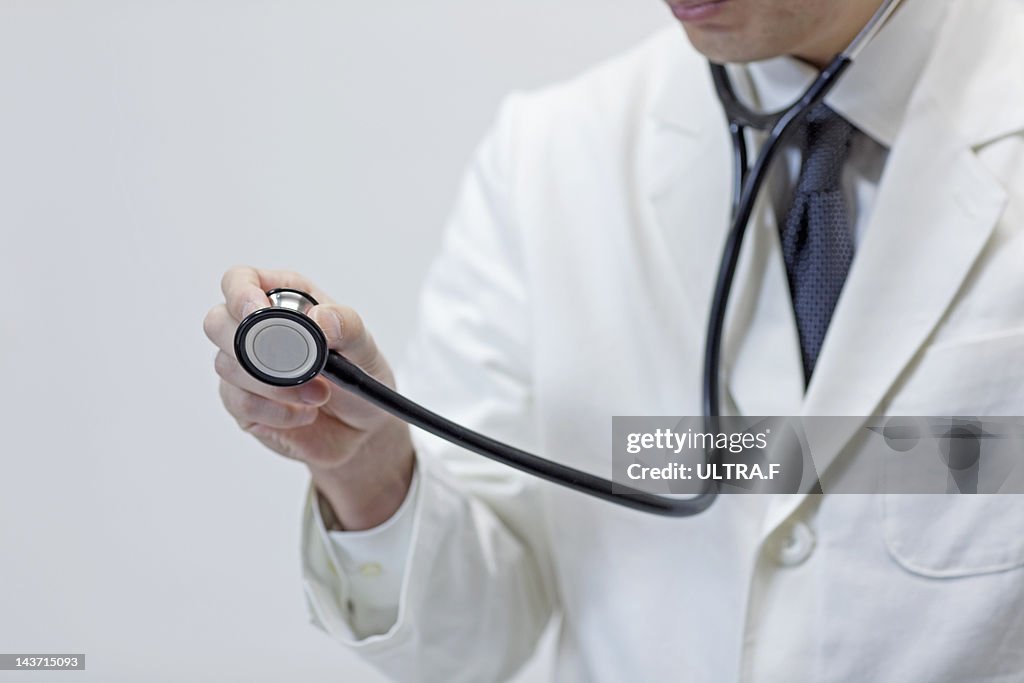 Doctor holding out stethoscope