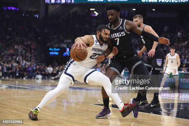 David Roddy of the Memphis Grizzlies is guarded by Chimezie Metu of the Sacramento Kings in the first quarter at Golden 1 Center on October 27, 2022...