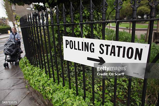 Woman walks past a sign for a polling station in North London as the public votes for the next Mayor of London and in local elections on May 3, 2012...