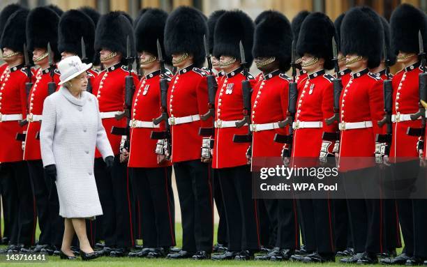 Queen Elizabeth II inspects the guards during a ceremony to present new colours to the 1st Battalion and No. 7 Company the Coldstream Guards at...