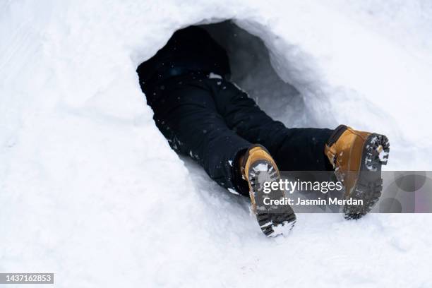 kid playing in snow, only feet out - hidden object stock pictures, royalty-free photos & images