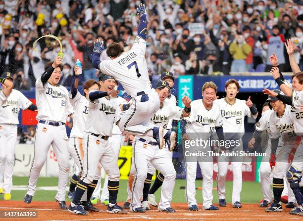Masataka Yoshida of the Orix Buffaloes is congratulated by his teammates on the home plate as he hits the game-winning two run home run in the 9th...