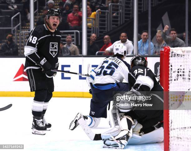 Brendan Lemieux of the Los Angeles Kings reacts to his roughing penalty on Mark Scheifele of the Winnipeg Jets in front of Jonathan Quick, trailing...