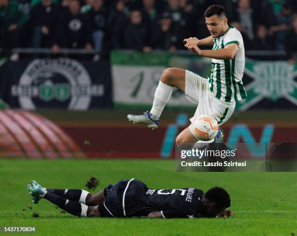 Benoit Badiashile of AS Monaco slide tackles Amer Gojak of Ferencvarosi TC during the UEFA Europa League group H match between Ferencvarosi TC and AS...