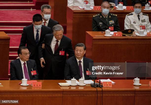 Chinese President Xi Jinping and Premier Li Keqiang, look on as former President Hu Jintao, , speaks to Xi Jinping as he is helped to leave early...