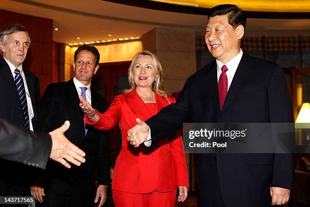 China's Vice President Xi Jinping meets U.S. Secretary of State Hillary Clinton , U.S. Treasury Secretary Timothy Geithner and other delegates during...