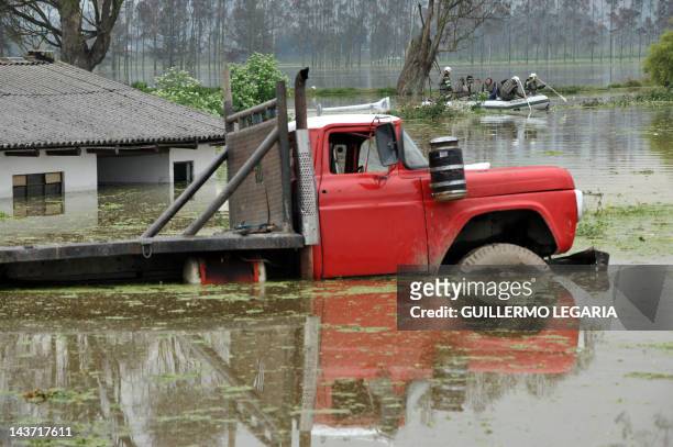 View of a truck stranded in a flooded farm in the municipality of Cota, outskirts of Bogota, Colombia, on April 18, 2012. Up to now, the first rainy...