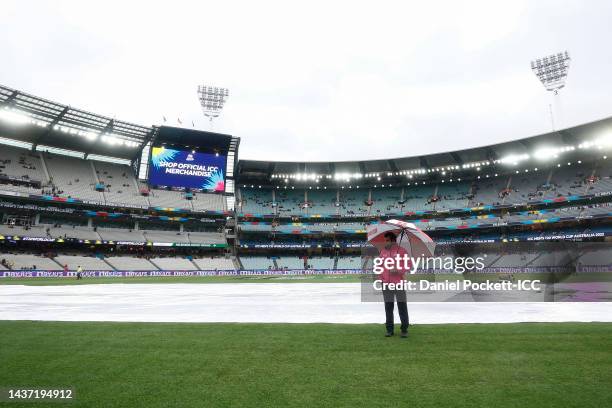 Umpirew Aleem Dar inspects the field as rain delays play during the ICC Men's T20 World Cup match between England and Australia at Melbourne Cricket...