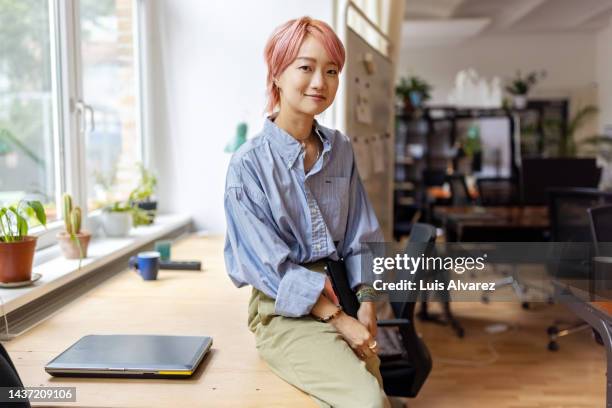 portrait of confident creative businesswoman smiling in office - designer female stock pictures, royalty-free photos & images