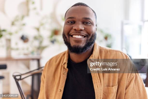 close-up portrait of a smiling african businessman in office - endast en man bildbanksfoton och bilder