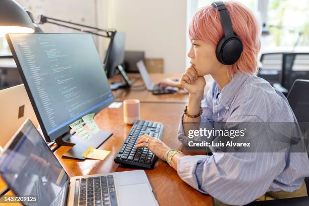 businesswoman coding on computer at coworking office - computer programmer stock-fotos und bilder