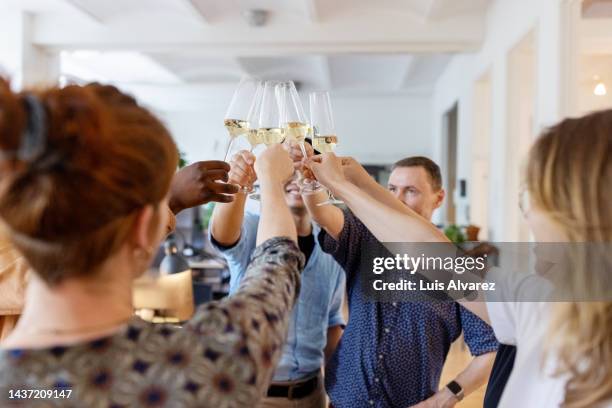 multi-ethnic business people toasting champagne in office - honour board stock pictures, royalty-free photos & images