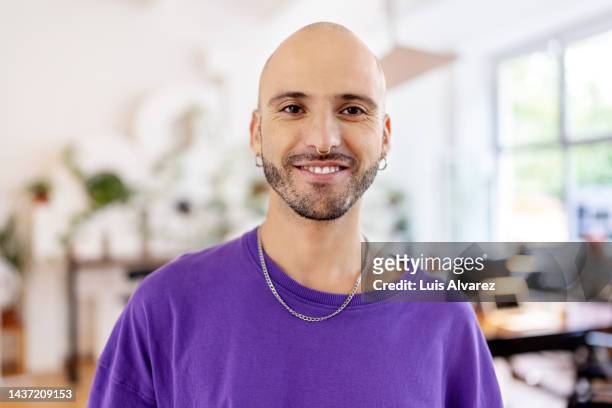 close-up portrait of a bald businessman standing in office - bald man foto e immagini stock