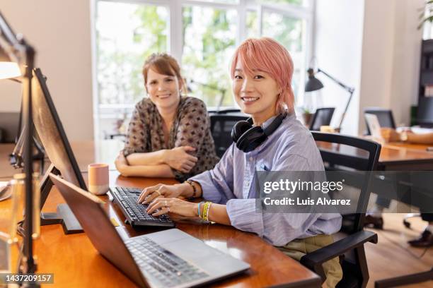 portrait of two female professionals working together on a project - code 41 bildbanksfoton och bilder