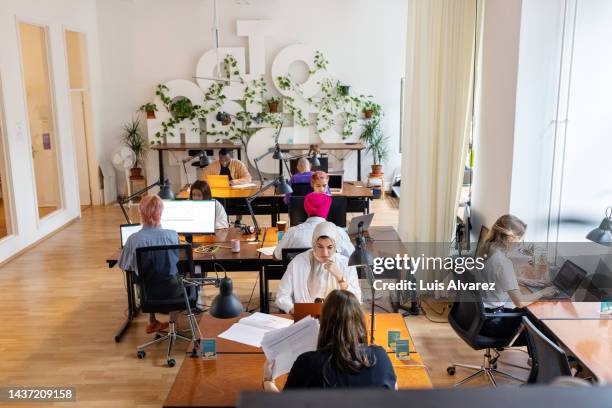 business people working at open plan coworking office - code 41 stock pictures, royalty-free photos & images