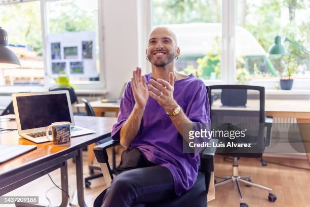 bald business professional clapping hands in office - man applauding stock pictures, royalty-free photos & images