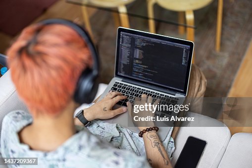 Software engineer coding on laptop at office Software engineer coding on laptop at office