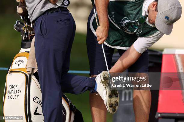 Caddie helps to clean the shoes of Jorge Campillo of Spain during Day Two of the Portugal Masters at Dom Pedro Victoria Golf Course on October 28,...