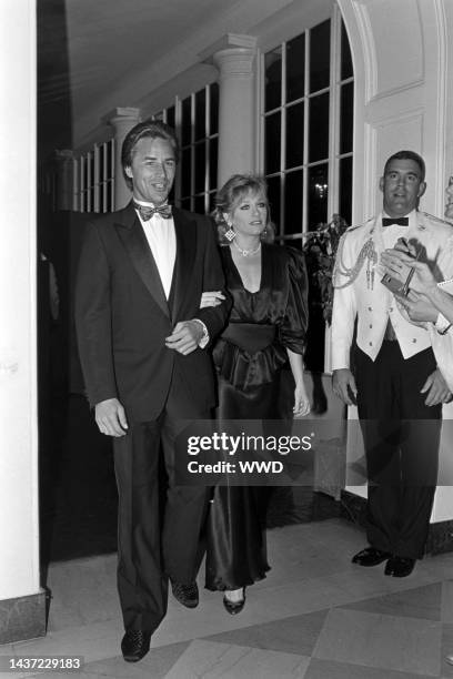 Don Johnson, Patti D'Arbanville, and a military escort attend an event at the White House in Washington, D.C., on September 10, 1985.