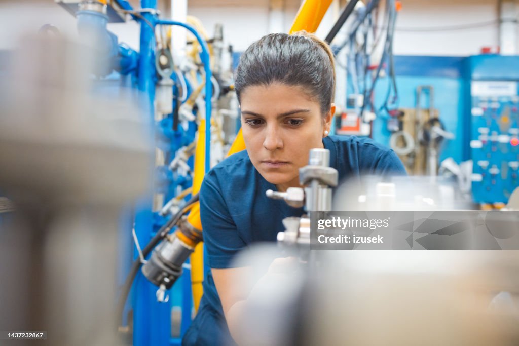 Engineering Working Machine Concentrated Engineer Analyzing Machinery While Working In Factory High ...