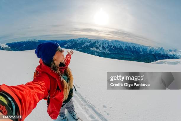 selfie of female skier in the mountains. - winter and sun stockfoto's en -beelden