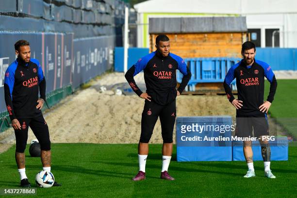 Neymar Jr, Kylian Mbappe and Leo Messi look on during a Paris Saint-Germain training session at PSG training center on October 28, 2022 in Paris,...
