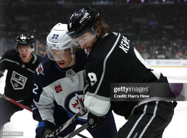 Adrian Kempe of the Los Angeles Kings checks Mason Appleton of the Winnipeg Jets in front of Mikey Anderson during a 6-4 Jets win at Crypto.com Arena...