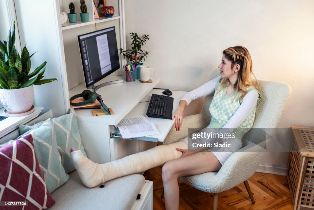 Legs At Computer A Student Girl With Leg In Plaster Using Computer And Books For ...