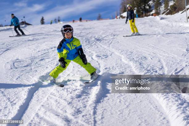 boy enjoying skiing on sunny day - alpine skiing stock pictures, royalty-free photos & images