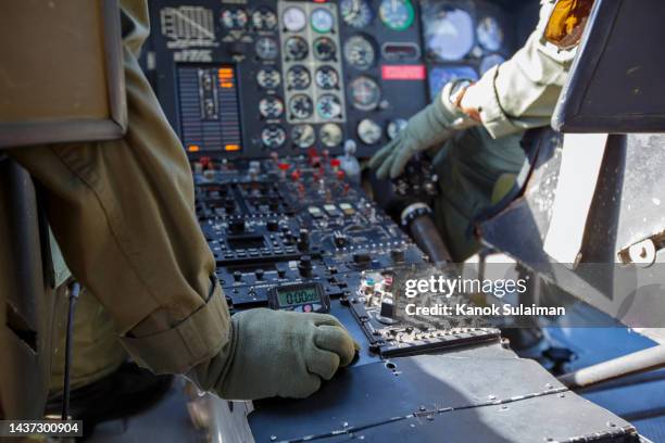 army pilot riding military helicopter - helicopter pilot stock pictures, royalty-free photos & images