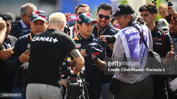 Sergio Perez of Mexico and Oracle Red Bull Racing is surrounded by media and fans in the Paddock prior to practice ahead of the F1 Grand Prix of...
