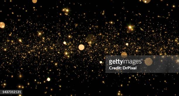 shiny golden particles - glittering ストックフォトと画像
