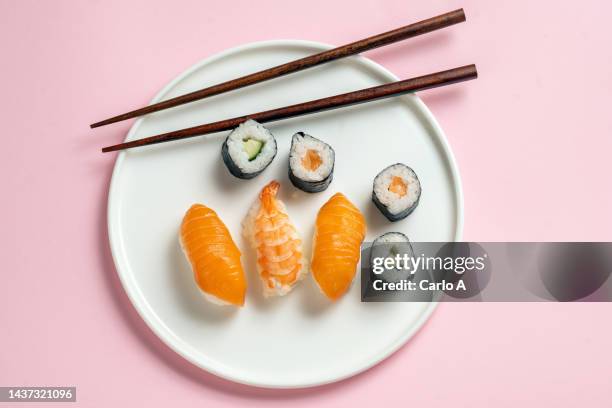 salmon sushi in a plate - sushi stock pictures, royalty-free photos & images
