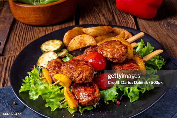 rustic meatballs skewers of tomato,paprika and baked potato qua - schaschlik stock-fotos und bilder