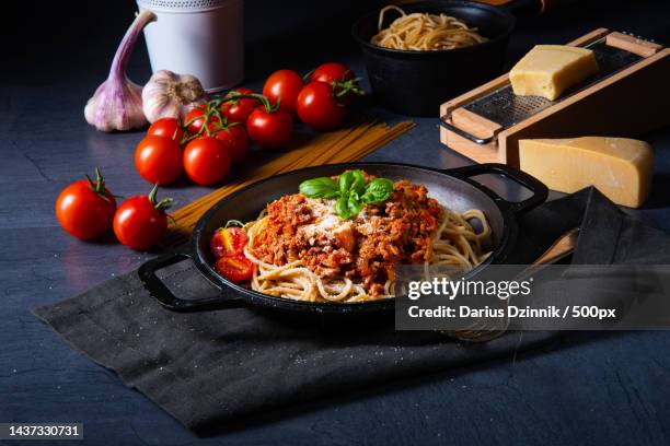 high angle view of pasta in bowl on table - tomatensoße stock-fotos und bilder