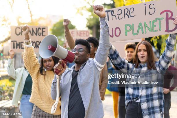 young people demonstrating for environmental conservation - climate emergency sign stock pictures, royalty-free photos & images
