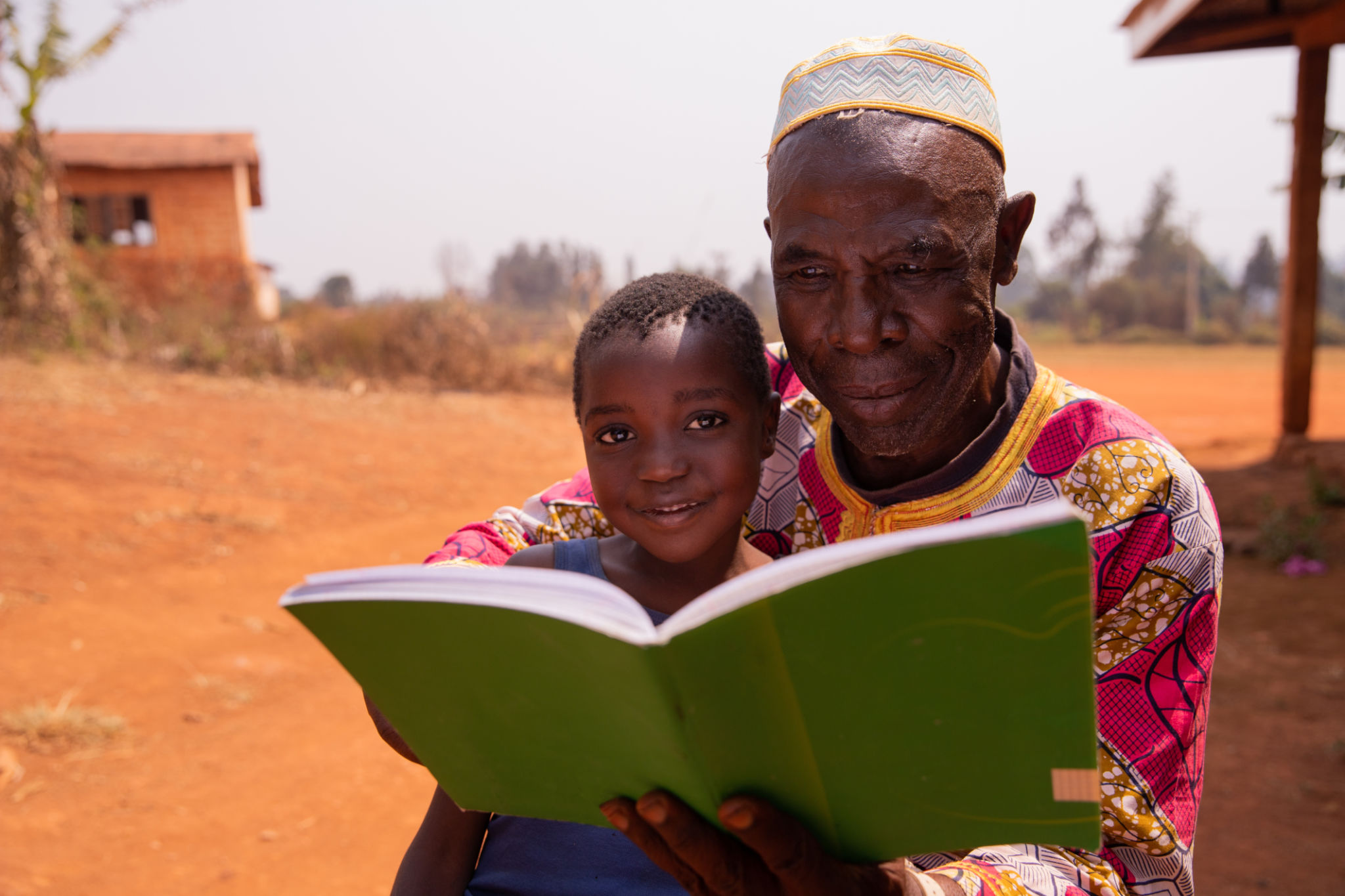 African grand father educating his grandson outdoor under the sun. Education concept African grand father educating his grandson outdoor under the sun. Education concept