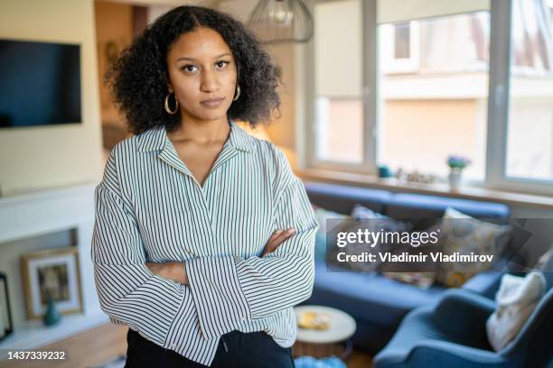 beautiful woman standing in living room - striped shirt stock pictures, royalty-free photos & images