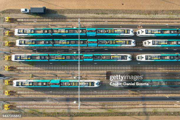 aerial view of rail yard with blue trains - yard line stock-fotos und bilder