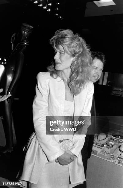 Fawn Hall and guest attend an event at the flagship Bloomingdale's store in New York City on April 6, 1988.